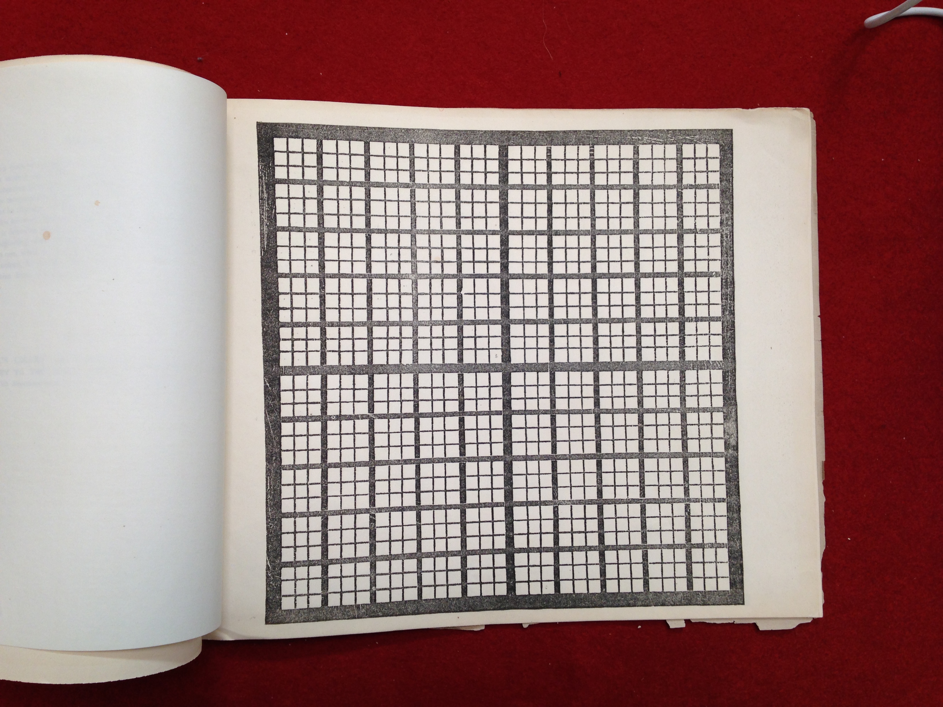 A page of a blank chart in Peabody’s workbook, set against a red backdrop.